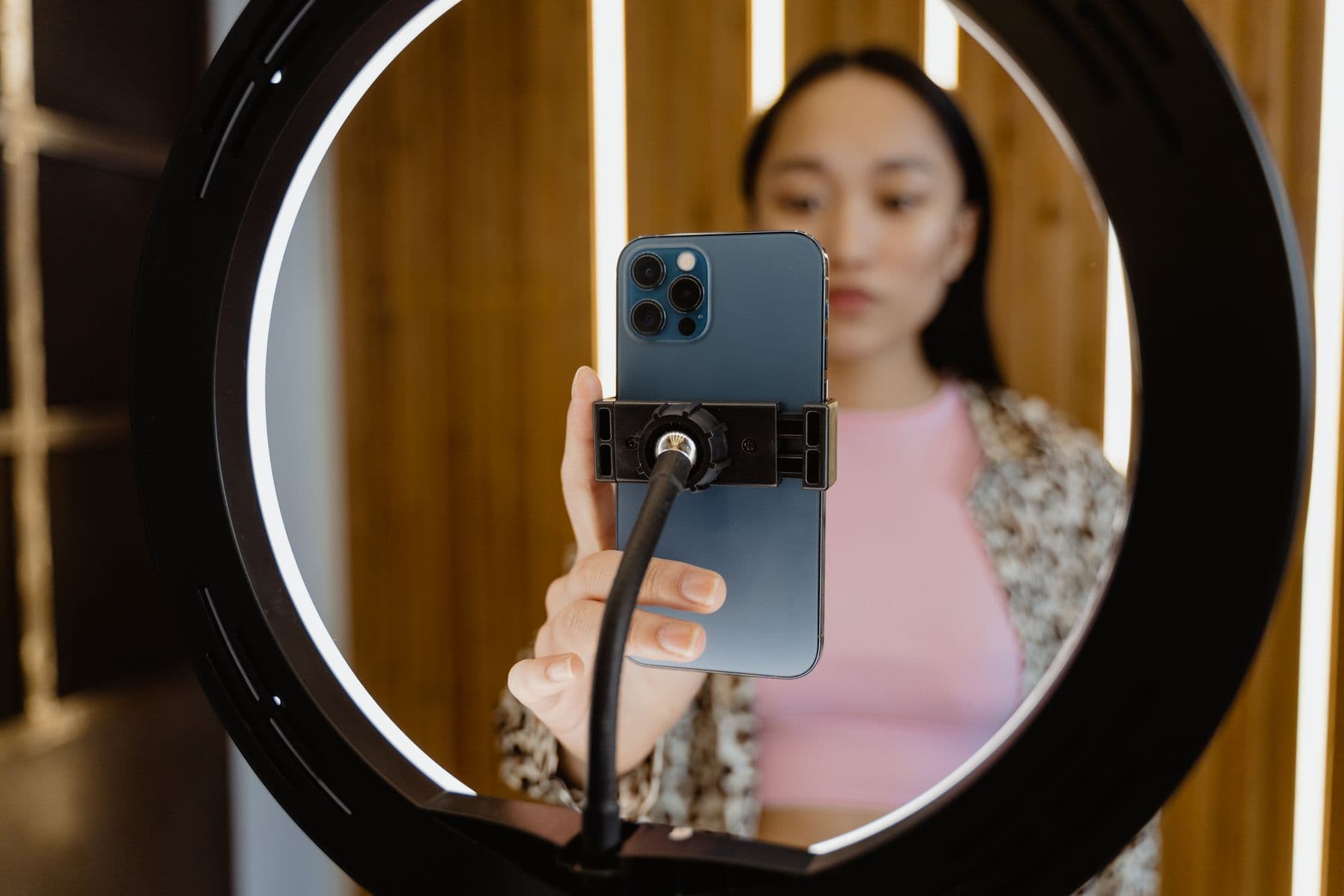 Hands placing a phone into a ring light
